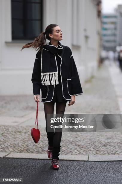 Celine Bethmann seen wearing gold earrings, Toteme dark grey wool scarf jacket, Massimo Dutti black suit shorts, Saint Sass black tights, Alaia dark...