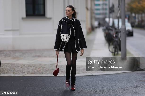 Celine Bethmann seen wearing gold earrings, Toteme dark grey wool scarf jacket, Massimo Dutti black suit shorts, Saint Sass black tights, Alaia dark...