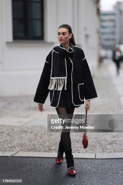 Celine Bethmann seen wearing gold earrings, Toteme dark grey wool scarf jacket, Massimo Dutti black suit shorts, Saint Sass black tights, Alaia dark...