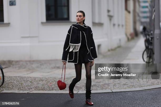 Celine Bethmann seen wearing gold earrings, Toteme dark grey wool scarf jacket, Massimo Dutti black suit shorts, Saint Sass black tights, Alaia dark...