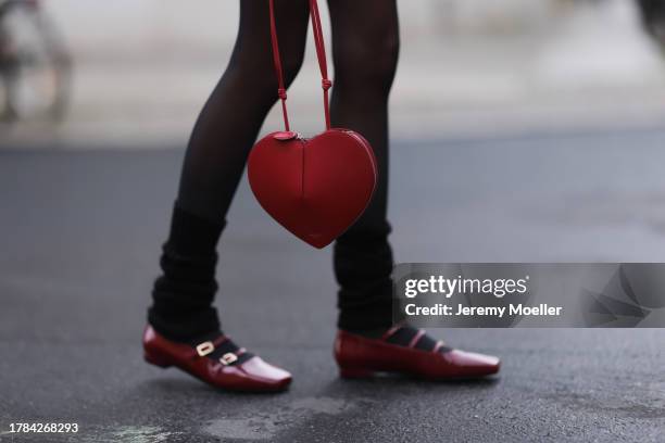 Celine Bethmann seen wearing Saint Sass black tights, Alaia dark red leather heart shaped bag, black wool knit socks, Alohas dark red varnished...