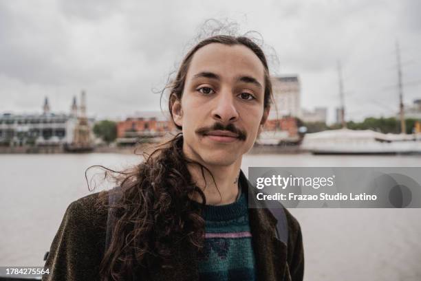 portrait of a young man in puerto madero, buenos aires - puerto stock pictures, royalty-free photos & images