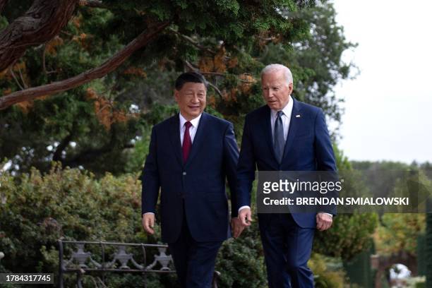 President Joe Biden and Chinese President Xi Jinping walk together after a meeting during the Asia-Pacific Economic Cooperation Leaders' week in...