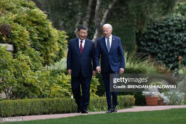 President Joe Biden and Chinese President Xi Jinping walk together after a meeting during the Asia-Pacific Economic Cooperation Leaders' week in...