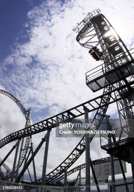 People ride on Fuji-Q Highland amusement park world's steepest roller coaster "Takabisha" with a free falling angle of 121 degrees, at a press...