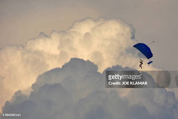 Paraglider flies over the athletic stadium on May 31, 2011 during the Zlata Tretra athletics meeting in the eastern Czech city of Ostrava. AFP PHOTO...