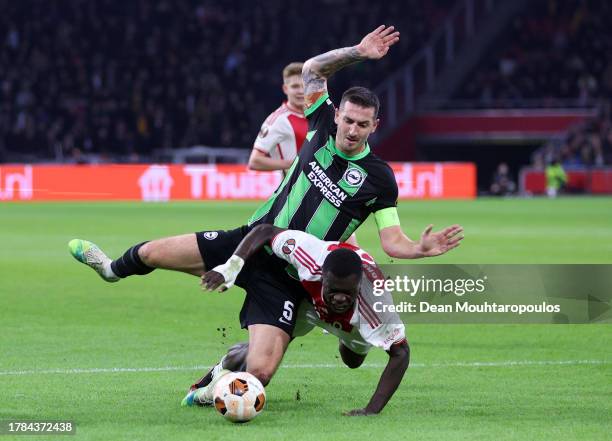 Lewis Dunk of Brighton & Hove Albion clashes with Brian Brobbey of Ajax during the UEFA Europa League 2023/24 match between AFC Ajax and Brighton &...