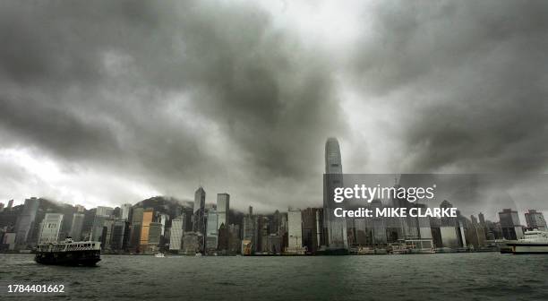 Storm clouds gather over the waterfront of Hong Kong island, 22 June 2005. A thunderstorm warning was issued for the territory with another day of...
