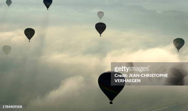 Hot air-balloons fly over a field near the Chambley-Bussieres air base, eastern France, 31 July 2007, during the "Lorraine Mondial Air Balloons"...