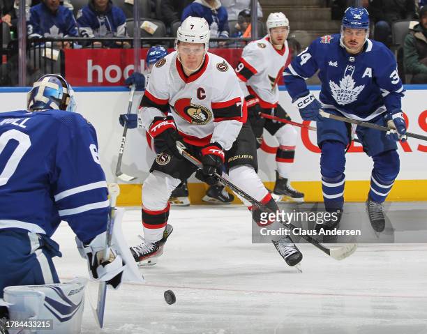 Brady Tkachuk of the Ottawa Senators skates after the puck against Joseph Woll of the Toronto Maple Leafs during the first period of an NHL game at...