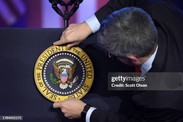 The presidential seal is placed on the lectern before President Joe Biden arrives to speak to autoworkers at the Community Complex Building on...