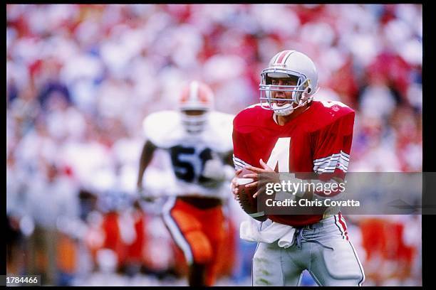 Quarterback Kirk Herbstreit of the Ohio State Buckeyes looks to pass the ball during a game against the Illinois Fighting Illini at Ohio Stadium in...