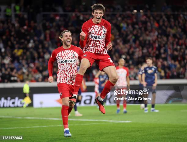 Merlin Roehl of Sport-Club Freiburg celebrates with teammate Lucas Hoeler after scoring the team's first goal during the UEFA Europa League match...