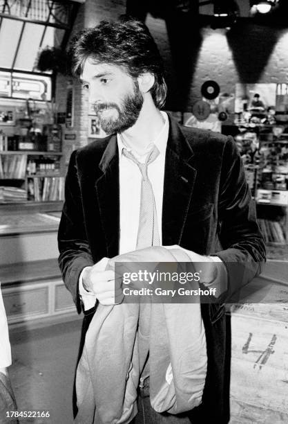 View of American Pop musician Kenny Loggins, holding a jacket, following an interview on MTV at Teletronic Studio, New York, New York, November 12,...