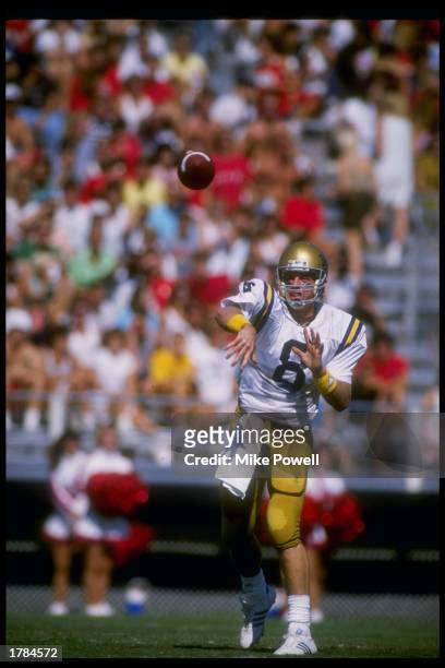 Quarterback Troy Aikman of the UCLA Bruins passes the ball during a game against the Arizona Wildcats at Arizona Stadium in Tucson, Arizona. UCLA won...