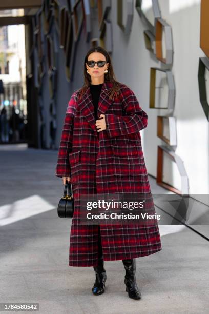 Zina Charkoplia wears red navy checkered Dior coat, grey pleadet Frankie Shop mini skirt, black Massimo Dutti sweater, knee high black Blanc sur...