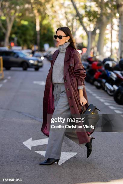 Zina Charkoplia wears grey Arket trousers, burgundy FWSS coat, grey Choux turtleneck sweater, black Arket boots, black Hermes bag, YSL sunnies on...