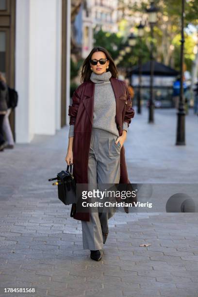 Zina Charkoplia wears grey Arket trousers, burgundy FWSS coat, grey Choux turtleneck sweater, black Arket boots, black Hermes bag, YSL sunnies on...