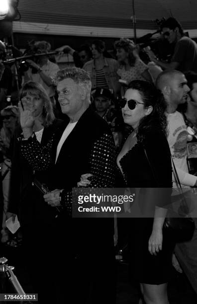 Tony Curtis and Lisa Deutsch attend the premiere of "True Lies" in Westwood, California, on July 15, 1994.