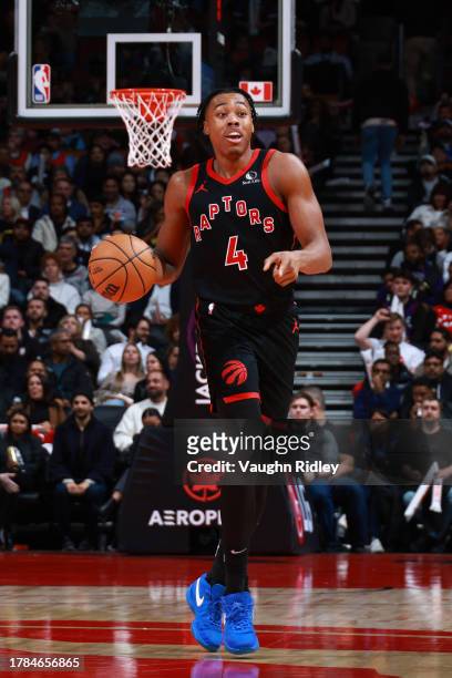 Scottie Barnes of the Toronto Raptors dribbles the ball during the game against the Milwaukee Bucks on November 15, 2023 at the Scotiabank Arena in...