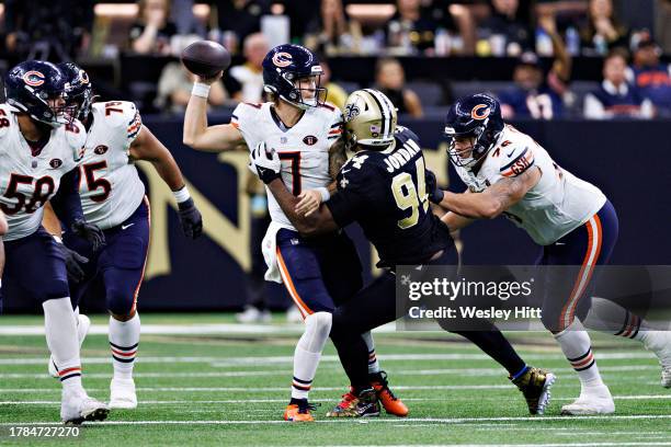 Tyson Bagent of the Chicago Bears throws a pass and is hit by Cameron Jordan of the New Orleans Saints at Caesars Superdome on November 5, 2023 in...