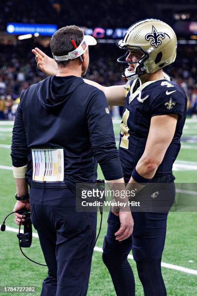 Head Coach Dennis Allen talks on the sidelines with Derek Carr of the New Orleans Saints during a game against the Chicago Bears at Caesars Superdome...