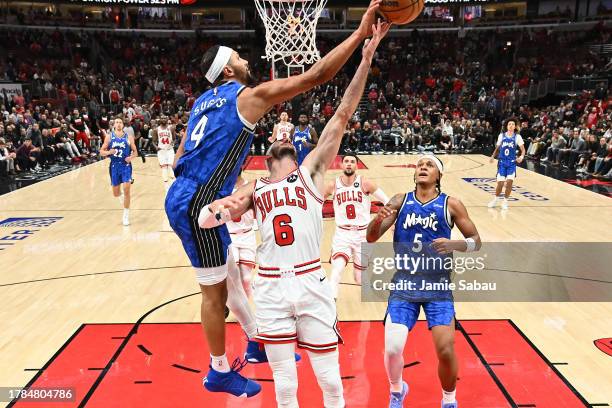 Jalen Suggs of the Orlando Magic fouls Alex Caruso of the Chicago Bulls in the second half at United Center on November 15, 2023 in Chicago,...