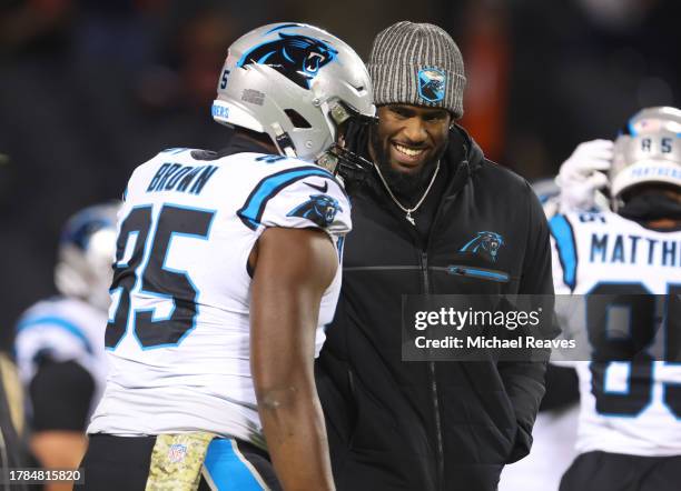 Brian Burns and Derrick Brown of the Carolina Panthers talk prior to a game against the Chicago Bears at Soldier Field on November 09, 2023 in...