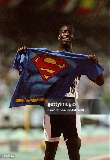 Michael Johnson of the United States displays a Superman shirt after winning a 400 meter event during the World Championships at Olympic Stadium in...