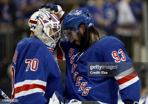 Louis Domingue of the New York Rangers is congratulated by Mika Zibanejad after the game against the Minnesota Wild at Madison Square Garden on...