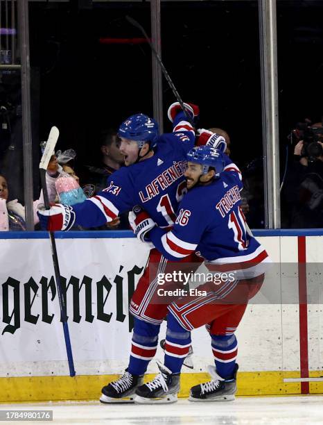 Alexis Lafreniere of the New York Rangers celebrates his goal with teammate Vincent Trocheck during the third period against the Minnesota Wild at...