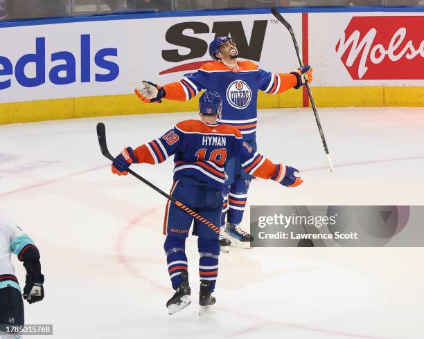 Evander Kane and Zach Hyman of the Edmonton Oilers celebrate his hat-trick goal in overtime against the Seattle Kraken at Rogers Place on November...