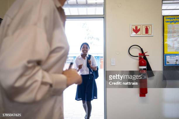 young schoolgirl arrives late for her lesson - arriving late class stockfoto's en -beelden