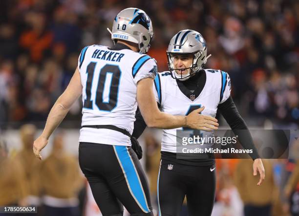 Eddy Pineiro of the Carolina Panthers celebrates with Johnny Hekker after a field goal during the fourth quarter against the Chicago Bears at Soldier...