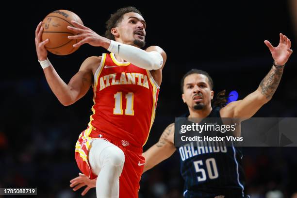 Trae Young of the Atlanta Hawks goes up for a layup against Cole Anthony of the Orlando Magic during the game between the Atlanta Hawks and Orlando...