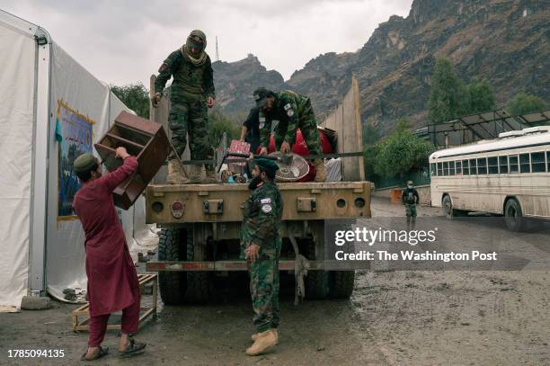 Mohammad Adnan Junudi the taliban military official in charge of reception operations at the Torkham border crossing in Eastern Afghanistan, helps...