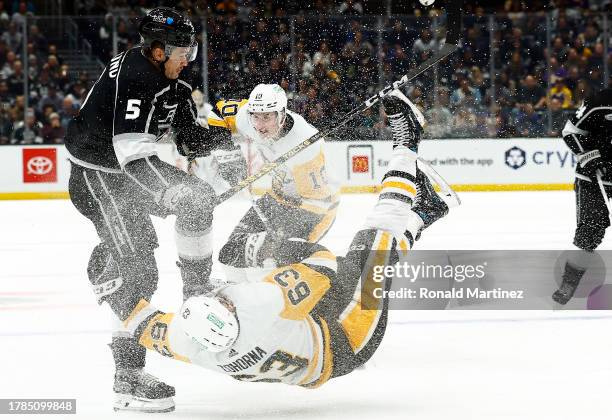 Radim Zohorna of the Pittsburgh Penguins is checked by Andreas Englund of the Los Angeles Kings in the first period at Crypto.com Arena on November...