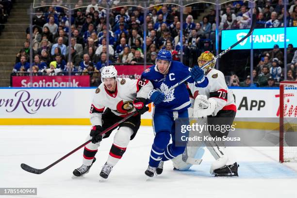 John Tavares of the Toronto Maple Leafs battles for position against Travis Hamonic of the Ottawa Senators during the second period at the Scotiabank...