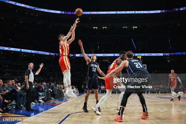 Bogdan Bogdanovic of the Atlanta Hawks shoots over Cole Anthony of the Orlando Magic during the game between the Atlanta Hawks and Orlando Magic as...