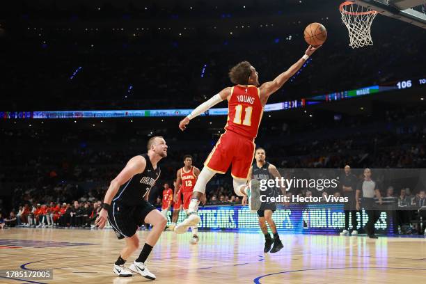 Trae Young of the Atlanta Hawks goes up for a layup against Joe Ingles of the Orlando Magic during the game between the Atlanta Hawks and Orlando...