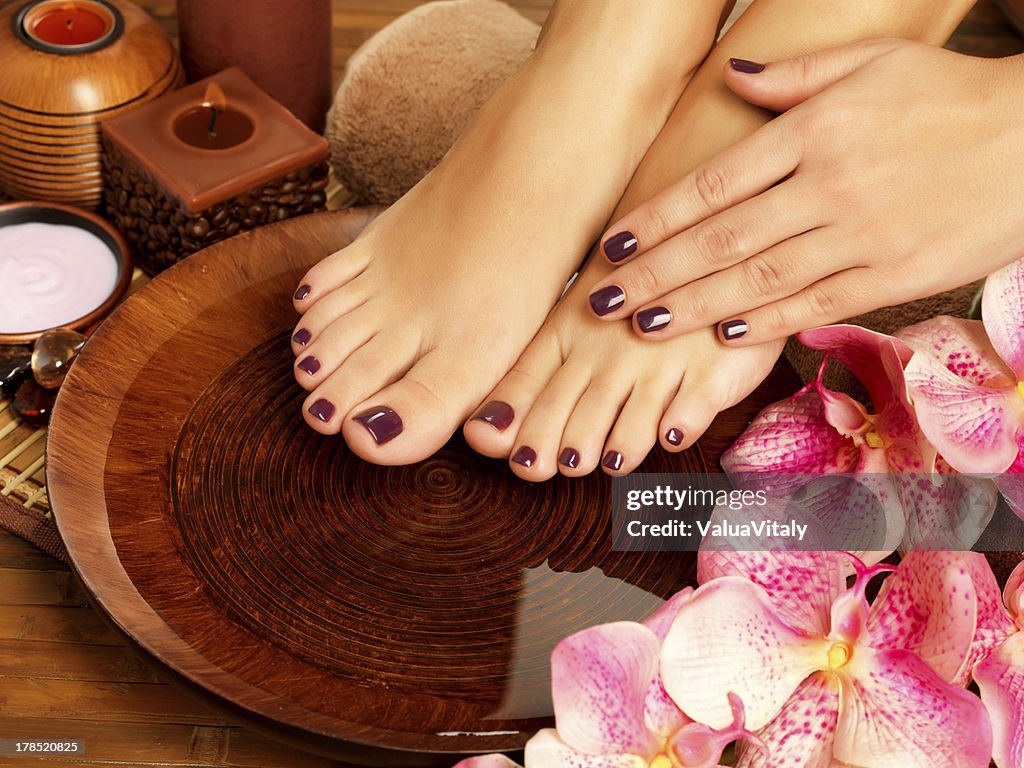 Female feet at spa salon on pedicure procedure