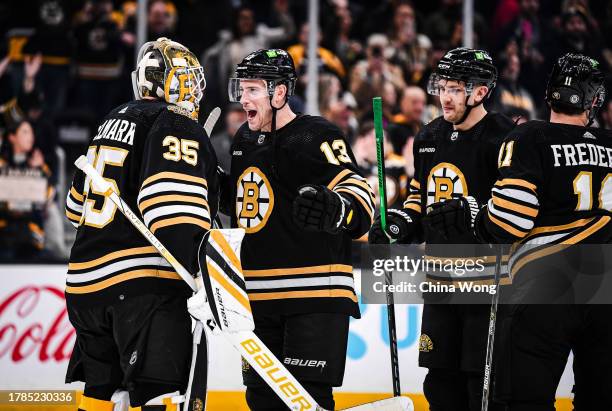 Charlie Coyle and Linus Ullmark of the Boston Bruins celebrate a win against the New York Islanders at TD Garden on November 09, 2023 in Boston,...