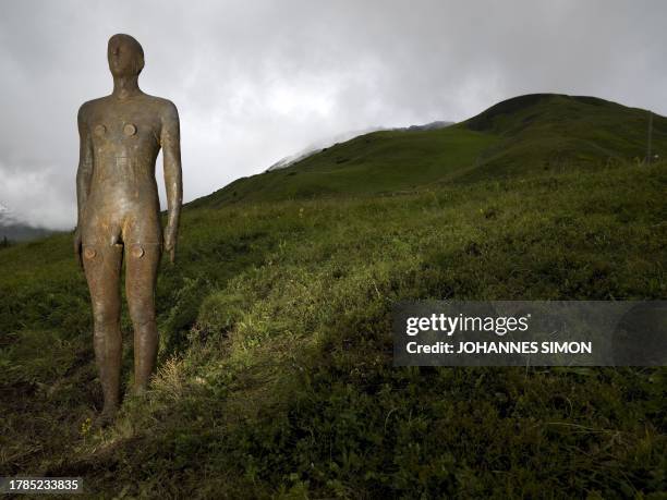 Life size bronze figure by British artist Antony Gormley is seen near the Kriegeralpe mountain pasture in the Austrian village Lech am Arlberg on...