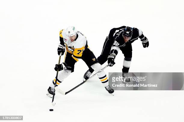 Evgeni Malkin of the Pittsburgh Penguins skates the puck against Pierre-Luc Dubois of the Los Angeles Kings in the third period at Crypto.com Arena...