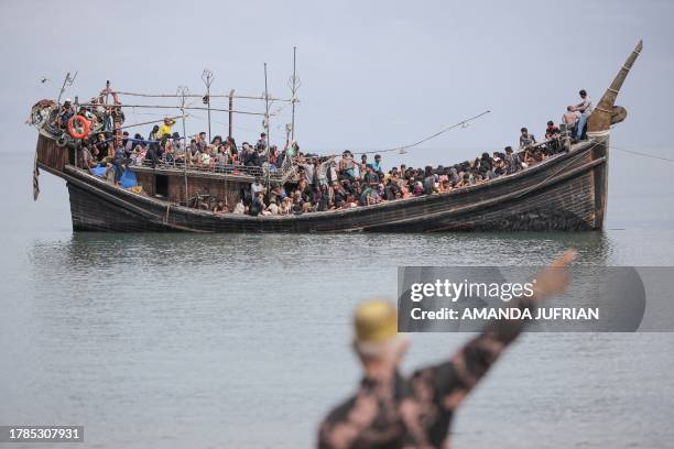 Newly arrived Rohingya refugees are stranded on a boat after the nearby community decided not to allow them to land after giving them water and food...