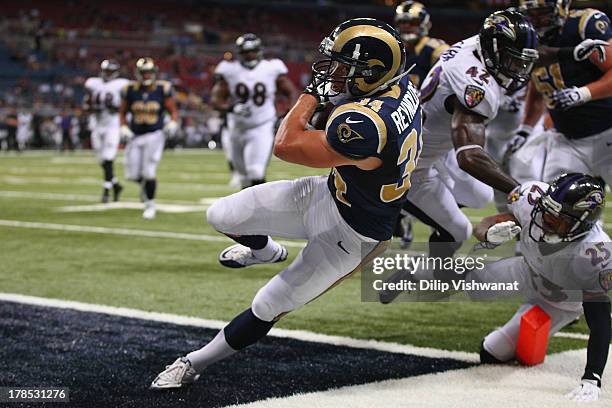 Chase Reynolds of the St. Louis Rams scores a touchdown against the Baltimore Ravens during a pre-season game at the Edward Jones Dome on August 29,...