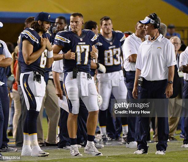 Charlie Whitehurst, Philip Rivers and Head Coach Mike McCoy of the San Diego Chargers stand together on the sidelines during a preseason game against...