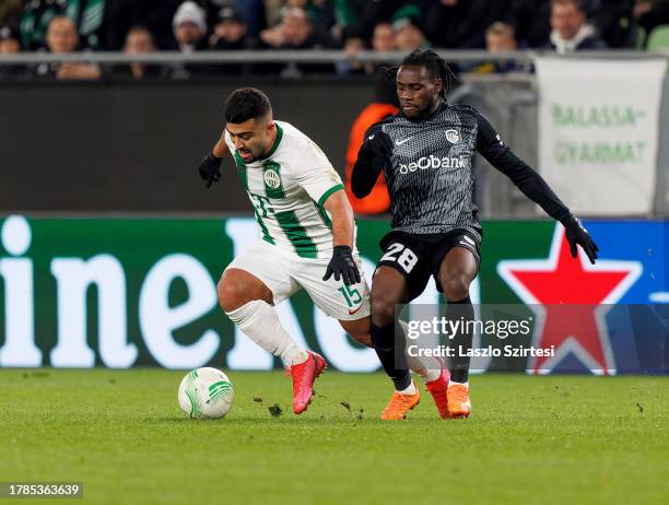 Joseph Paintsil of KRC Genk challenges Mohammad Abu Fani of Ferencvarosi TC during the UEFA Europa Conference League Group Stage match between...