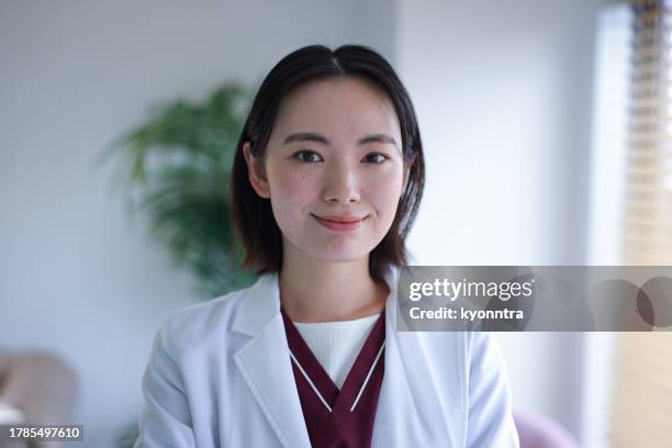 young female doctor looking at camera - medicare advantage stock pictures, royalty-free photos & images