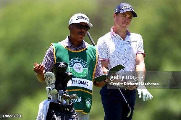 Justin Thomas of the United States and his caddie line up a shot on the 15th hole during Day Two of the Nedbank Golf Challenge at Gary Player CC on...